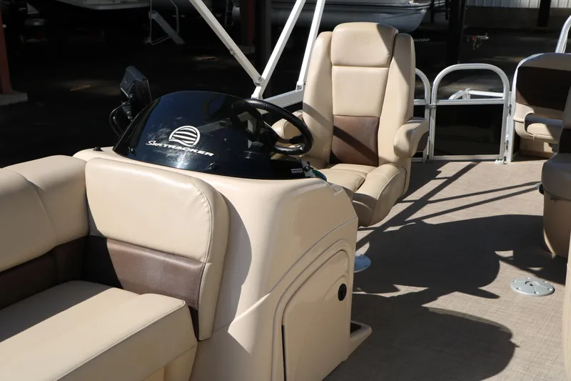 Slide: The Image of 2019 Sun Tracker SportFish 22 XP3 boat interior with beige seating and steering console. - 23