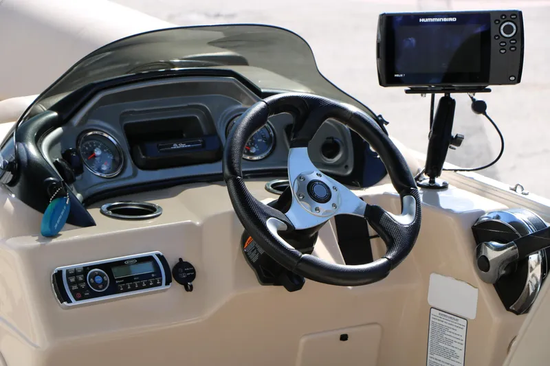 Slide: The Image of Steering console of 2019 Sun Tracker SportFish 22 XP3 with navigation system. - 34
