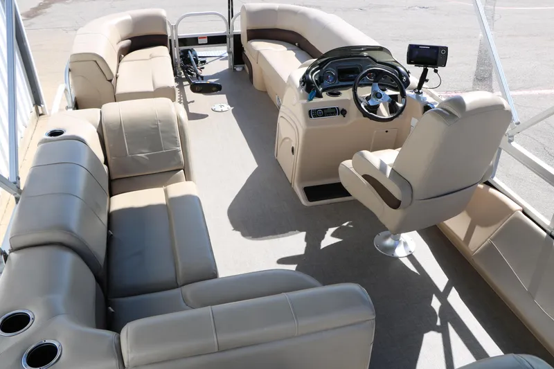 Slide: The Image of 2019 Sun Tracker SportFish 22 XP3 pontoon boat interior with beige seating and steering console. - 38