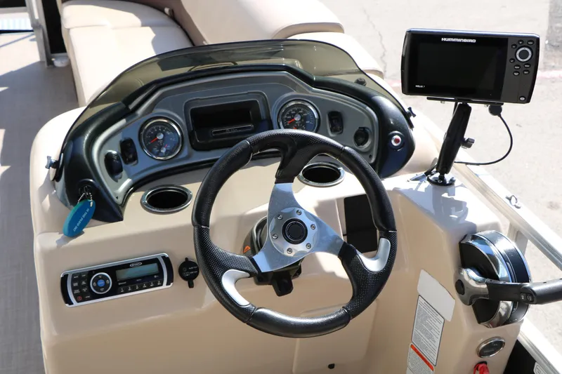 Slide: The Image of 2019 Sun Tracker SportFish 22 XP3 dashboard with steering wheel and navigation system. - 41