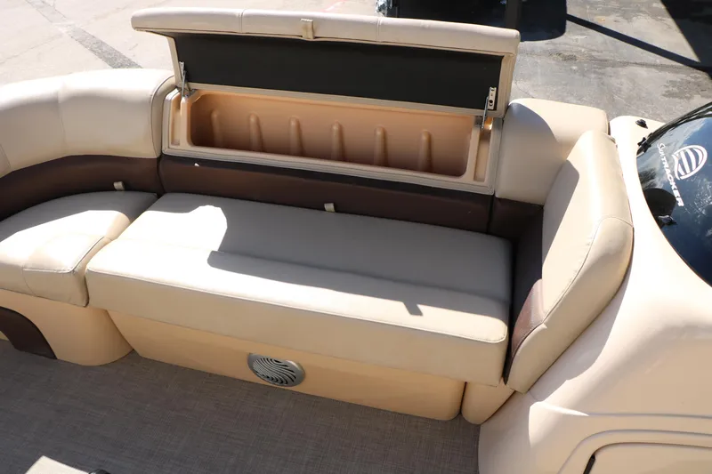 Slide: The Image of 2019 Sun Tracker SportFish 22 XP3 boat interior with beige seating and storage compartment. - 47