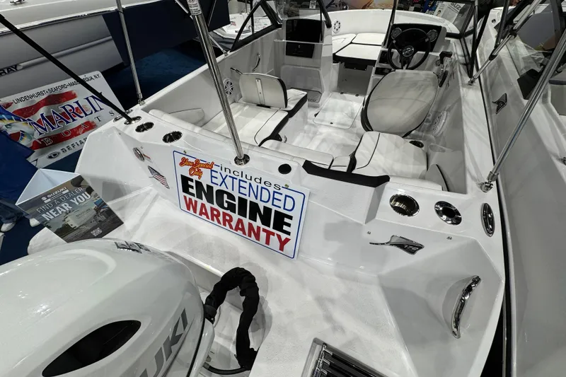 Slide: The Image of 2026 Stingray 172 DC boat interior with extended engine warranty sign. - 10