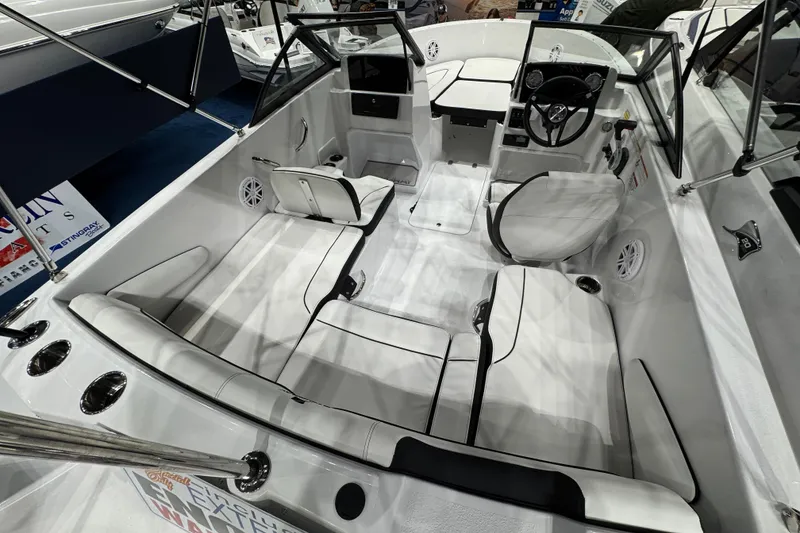 Slide: The Image of 2026 Stingray 172 DC boat interior with white seating and modern dashboard design. - 11