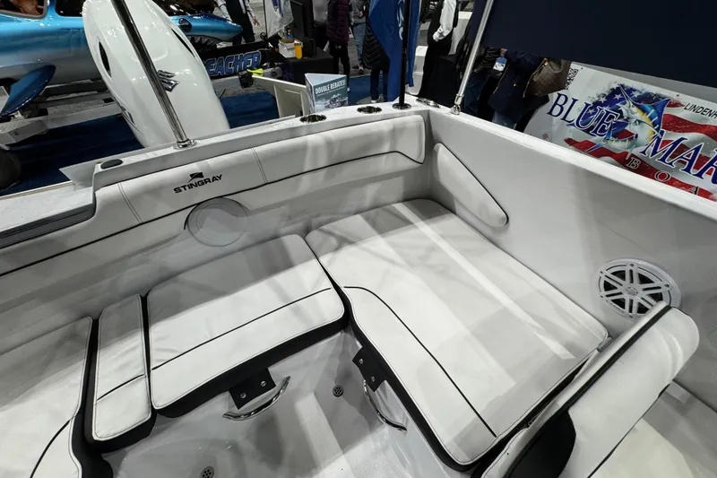 Slide: The Image of 2026 Stingray 172 DC boat interior with white seating and speaker detail. - 12