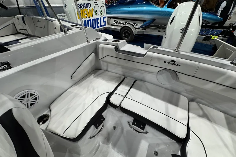 Slide: The Image of 2026 Stingray 172 DC boat interior with white seating and sleek design. - 13