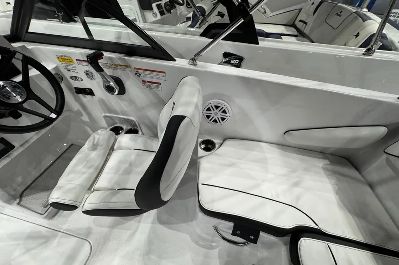 Slide: The Image of 2026 Stingray 172 DC boat interior with white seating and steering wheel. - 16