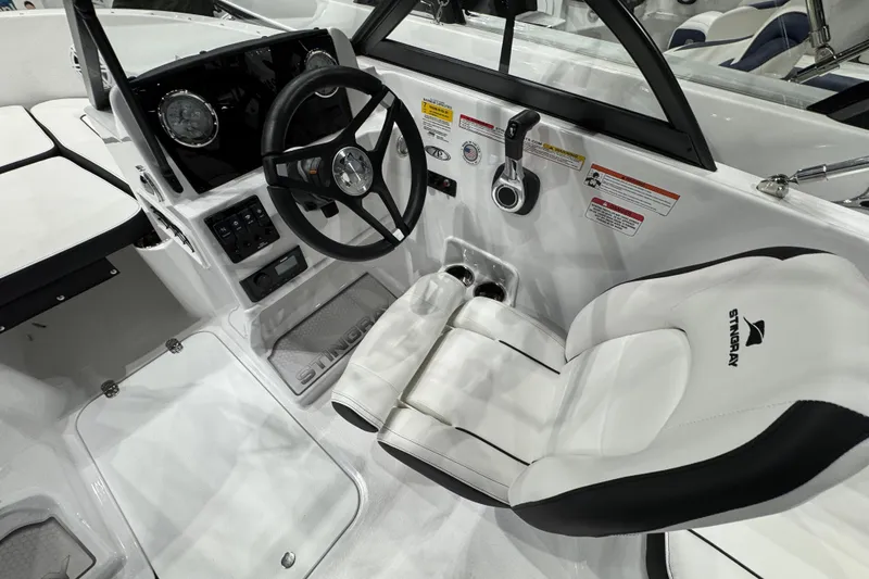 Slide: The Image of 2026 Stingray 172 DC boat interior with steering wheel and white seating. - 17