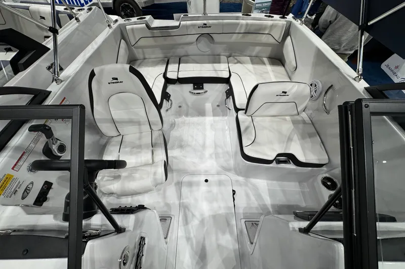 Slide: The Image of 2026 Stingray 172 DC boat interior with white seating and steering console. - 24
