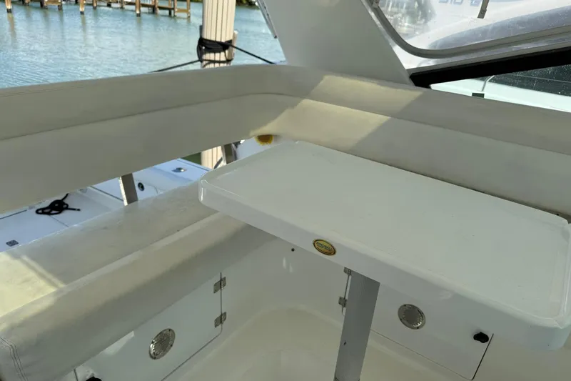 Slide: The Image of 2001 Tiara Yachts 4300 Open interior with seating and table, dockside view. - 10