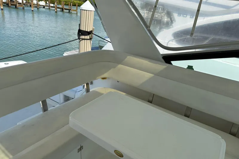 Slide: The Image of Interior view of 2001 Tiara Yachts 4300 Open, featuring seating and table by the water. - 11