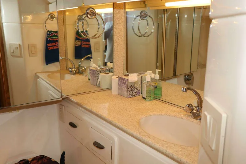 Slide: The Image of Bathroom vanity with mirror and sink on 2001 Tiara Yachts 4300 Open. - 17