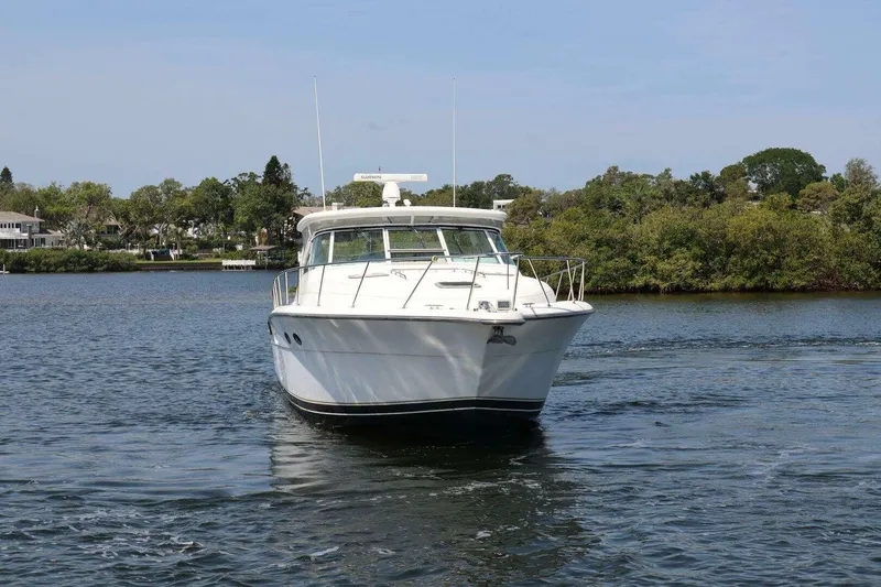 Slide: The Image of 2001 Tiara Yachts 4300 Open cruising on a serene waterway. - 2