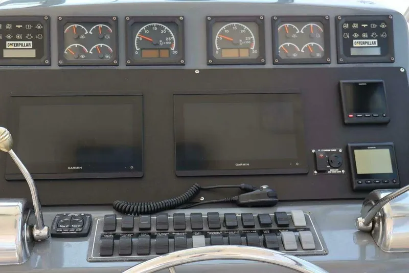 Slide: The Image of Dashboard of 2001 Tiara Yachts 4300 Open with Garmin displays and Caterpillar gauges. - 6