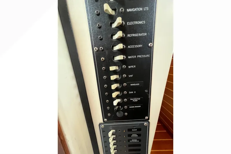 Slide: The Image of 1993 Nordic Tug 26 boat on stands, outdoor setting, clear sky, tree in background. - 100