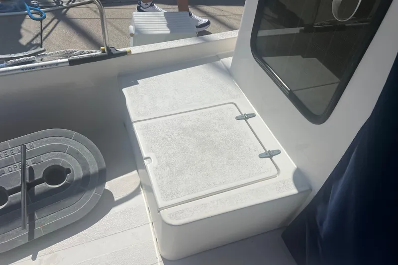 Slide: The Image of 1993 Nordic Tug 26 boat deck with storage compartment and railing. - 12