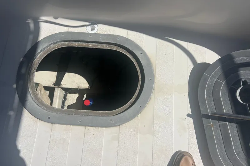 Slide: The Image of Interior view of a 1993 Nordic Tug 26 engine compartment with visible hoses and wiring. - 14