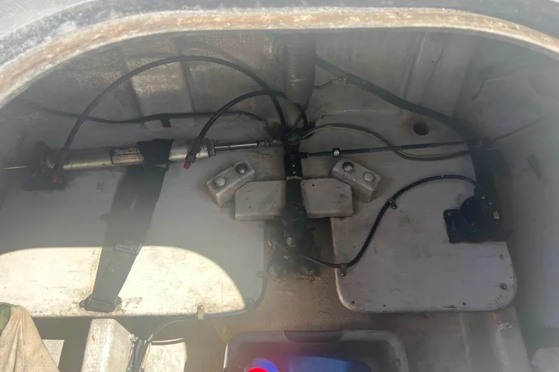 Slide: The Image of Interior of a 1993 Nordic Tug 26 showing mechanical components and storage area. - 16