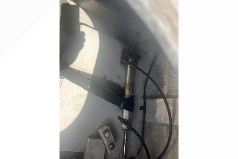 Slide: The Image of Engine compartment of a 1993 Nordic Tug 26 with oil containers and ropes. - 18