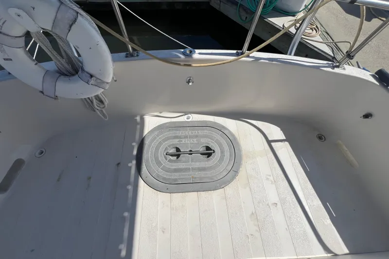 Slide: The Image of Nordic Tug 26 (1993) docked at marina, sunny day, clear sky, calm water. - 21