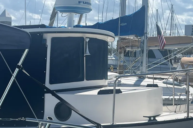 Slide: The Image of 1993 Nordic Tug 26 "Sea for Two" docked at marina under clear blue sky. - 3