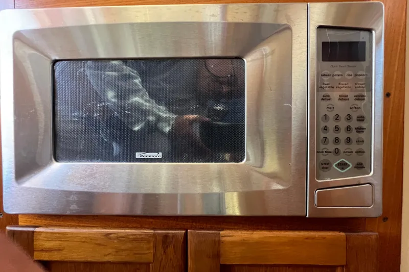 Slide: The Image of Interior of a 1993 Nordic Tug 26 with blue sofa and thermostat. - 34