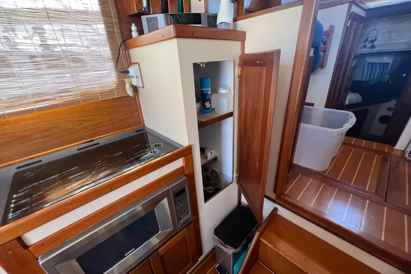 Slide: The Image of 1993 Nordic Tug 26 interior with microwave and wooden storage drawer. - 36