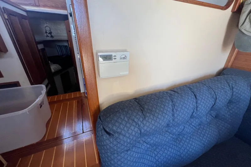 Slide: The Image of Storage area in a 1993 Nordic Tug 26 with water heater and supplies. - 37