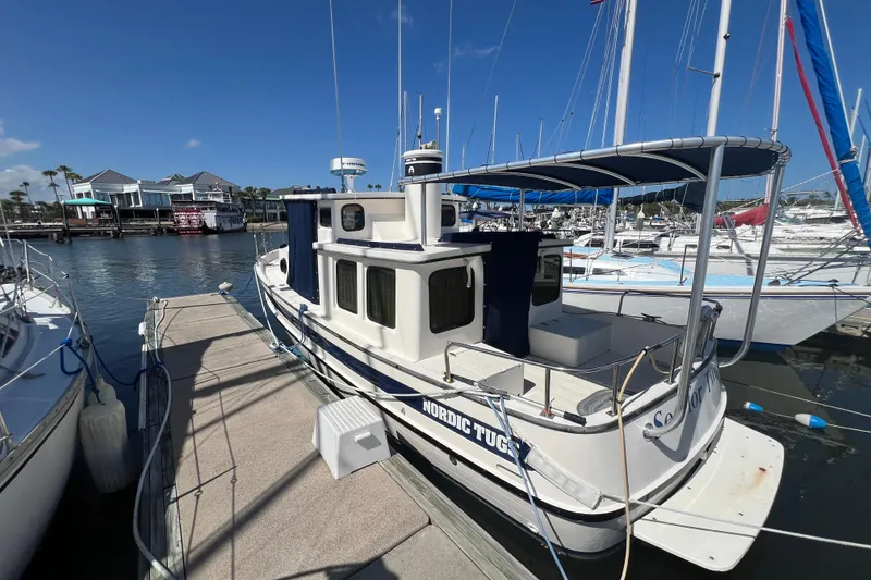 Slide: The Image of 1993 Nordic Tug 26 docked at marina with registration FL 5215 PC. - 5