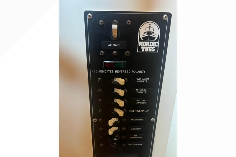 Slide: The Image of Red battery switch on a 1993 Nordic Tug 26, labeled "West Marine," Bellingham, WA. - 55