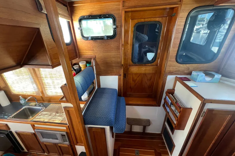 Slide: The Image of Interior of a 1993 Nordic Tug 26 with radio equipment and windows overlooking the water. - 59
