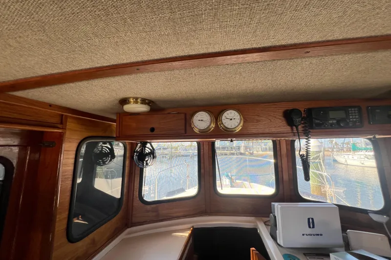 Slide: The Image of Interior of a 1993 Nordic Tug 26, featuring wood paneling and marine equipment. - 61