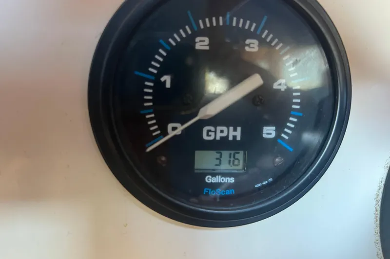 Slide: The Image of Interior of a 1993 Nordic Tug 26 with wooden finishes and blue seating. - 63