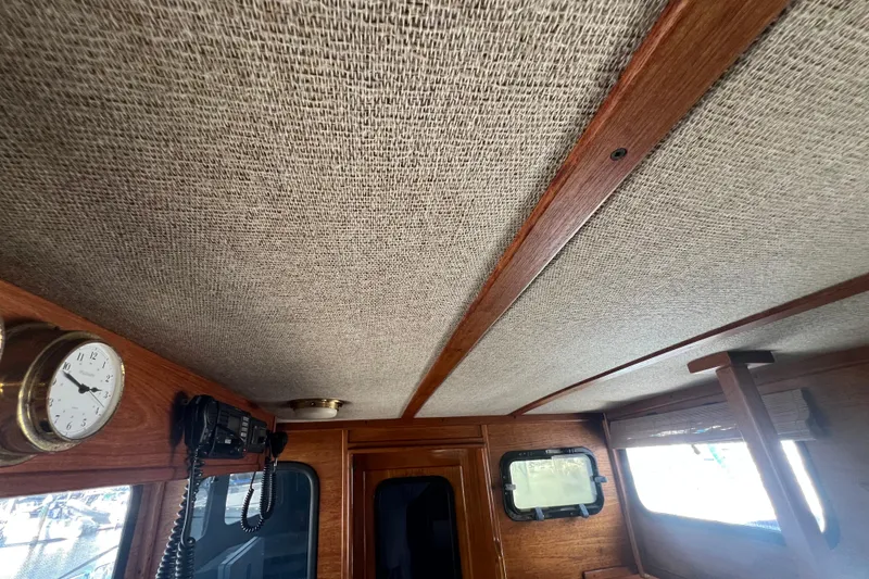 Slide: The Image of Interior of 1993 Nordic Tug 26 with wooden flooring and control panel. - 64