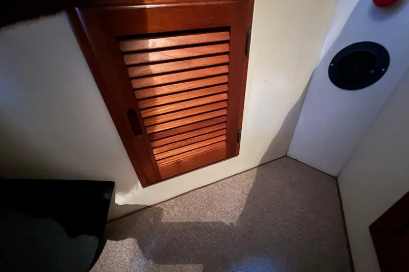 Slide: The Image of 1993 Nordic Tug 26 boat bathroom interior with compact toilet and wooden cabinetry. - 76