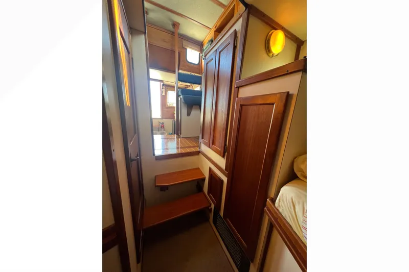 Slide: The Image of Interior of 1993 Nordic Tug 26 with porthole, mirror, and wooden accents. - 79