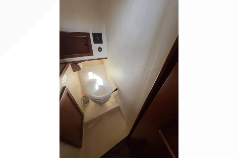 Slide: The Image of Engine compartment of a 1993 Nordic Tug 26 boat, showcasing mechanical components and hoses. - 81