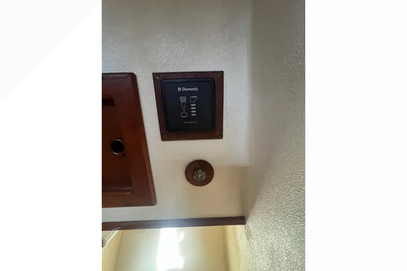 Slide: The Image of Engine compartment of a 1993 Nordic Tug 26, showcasing hoses and mechanical components. - 83