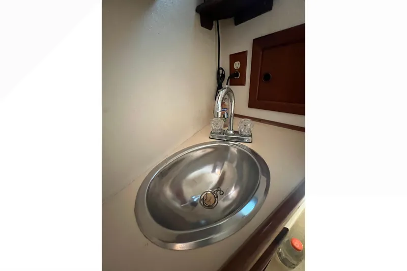 Slide: The Image of Engine compartment of a 1993 Nordic Tug 26 boat, showing detailed mechanical components. - 84