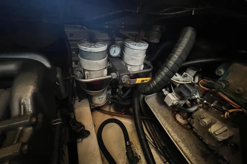 Slide: The Image of Engine compartment of a 1993 Nordic Tug 26 with visible wiring and components. - 88