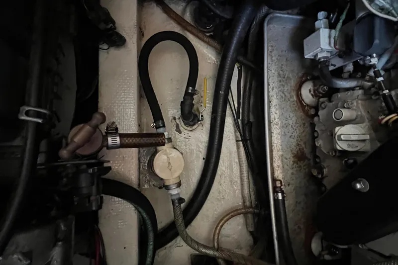 Slide: The Image of Engine room of a 1993 Nordic Tug 26 with visible wiring and components. - 89