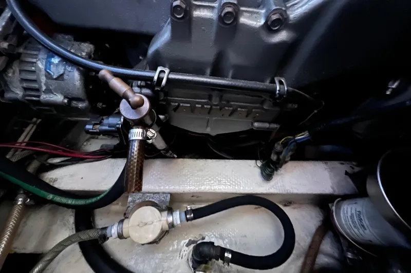 Slide: The Image of Engine compartment of a 1993 Nordic Tug 26, featuring wiring and mechanical components. - 91