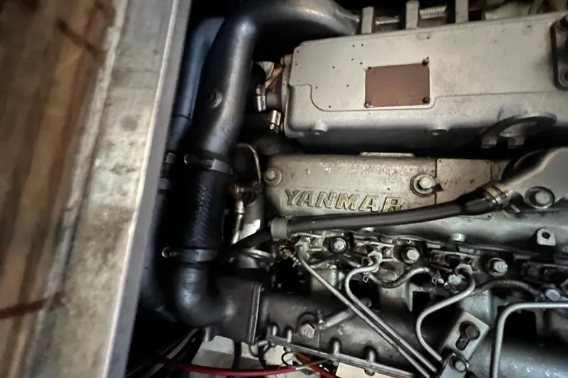 Slide: The Image of Engine compartment of a 1993 Nordic Tug 26, featuring mechanical components and wiring. - 92