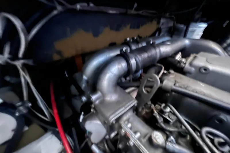 Slide: The Image of Engine of a 1993 Nordic Tug 26 boat, showcasing intricate mechanical components. - 93