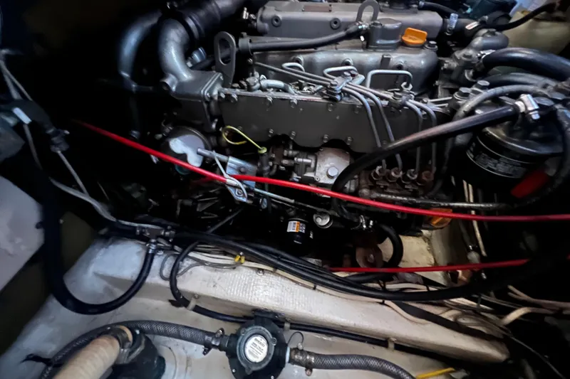 Slide: The Image of 1993 Nordic Tug 26 boat lifted at marina, clear sky background. - 96