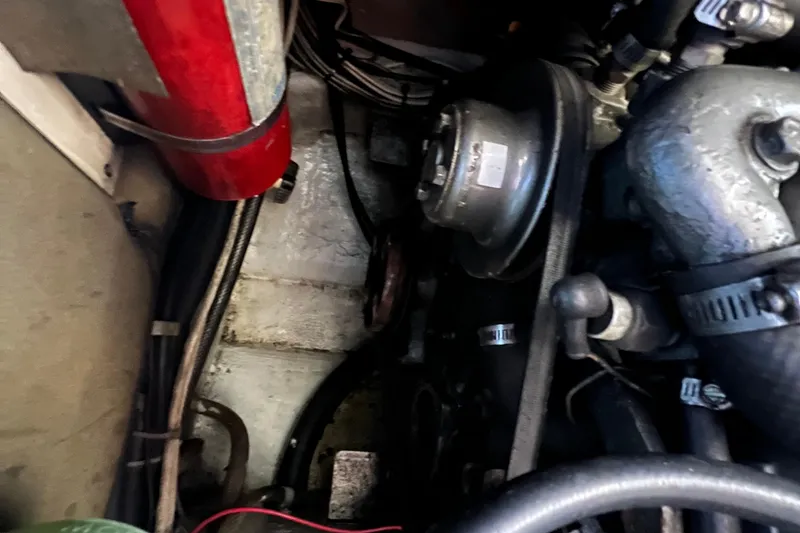 Slide: The Image of Nordic Tug 26 boat from 1993 being lifted at a marina under a blue sky. - 98