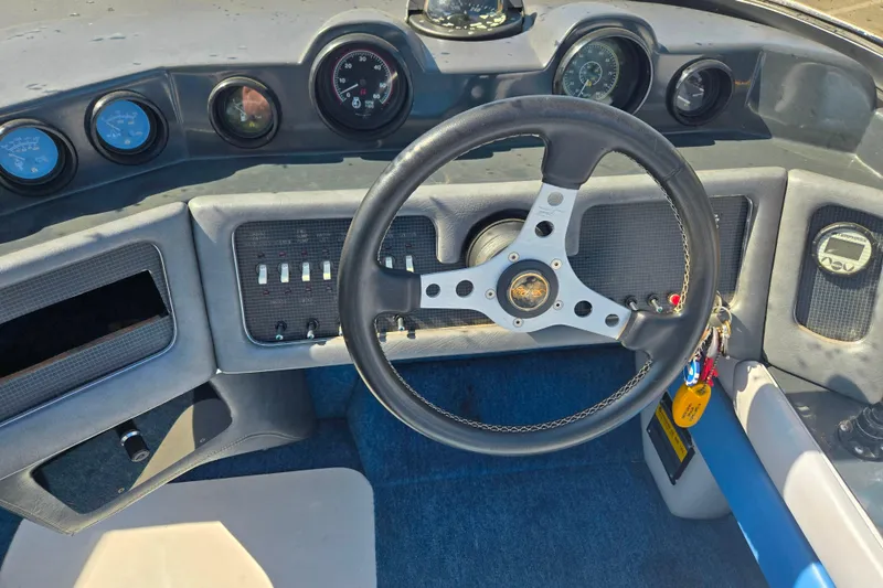 Slide: The Image of 1987 Sea Ray Pachanga 22 dashboard with steering wheel and instrument panel. - 12