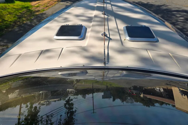 Slide: The Image of 1987 Sea Ray Pachanga 22 boat deck with dual hatches and sleek design. - 19