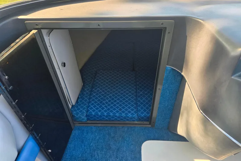 Slide: The Image of Interior cabin of 1987 Sea Ray Pachanga 22 with blue carpet and patterned upholstery. - 21