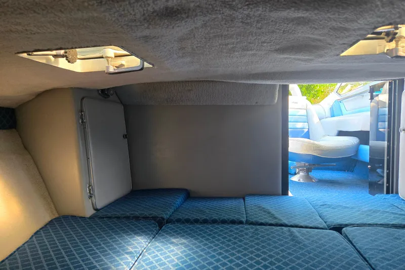 Slide: The Image of Interior cabin of 1987 Sea Ray Pachanga 22 boat with blue seating and storage. - 22