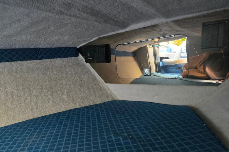 Slide: The Image of Interior cabin of 1987 Sea Ray Pachanga 22 with blue upholstery and speaker. - 23